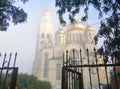 Orthodox church in the fog. Christianity. Open gate view of the church. Royalty Free Stock Photo