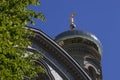 Orthodox church golden dome and cross on blue sky