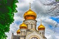 Orthodox Church, golden domes with crosses close-up against a blue cloudy sky, HDR photo Royalty Free Stock Photo