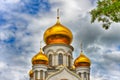 Orthodox Church, golden domes with crosses close-up against a blue cloudy sky, HDR photo Royalty Free Stock Photo