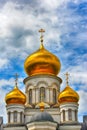 Orthodox Church, golden domes with crosses close-up against a blue cloudy sky, HDR photo Royalty Free Stock Photo