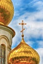 Orthodox Church, golden domes with crosses close-up against a blue cloudy sky, HDR photo Royalty Free Stock Photo