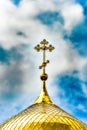 Orthodox Church, golden domes with crosses close-up against a blue cloudy sky, HDR photo Royalty Free Stock Photo