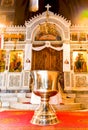 Orthodox church interior and baptism bowl in front of the carved temple Royalty Free Stock Photo