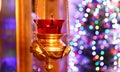 Orthodox church lamp with a lighted candle and red glass Royalty Free Stock Photo