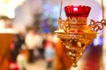 Orthodox church lamp with a lighted candle and red glass Royalty Free Stock Photo