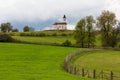 A Orthodox church in Serbia on a hillside on a pasture.