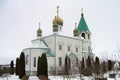 Orthodox church white walls green roof gold domes Christianity