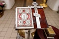 orthodox cross and bible on background of church interior