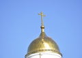 The Orthodox cross, on the dome of the city cathedral, shines in the rays Royalty Free Stock Photo