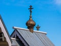 Orthodox cross on the roof of a religious building and a double-headed eagle - Russian coat of arms in the background Royalty Free Stock Photo