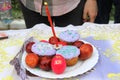 Orthodox Easter, preparation for consecration with Holy water. Easter cakes with a candle and colorful Easter eggs on background Royalty Free Stock Photo