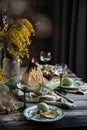 Orthodox Easter table setting with caramel easter cottage cheese cake on wooden light green board on grey wooden table