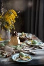 Orthodox Easter table setting with caramel easter cottage cheese cake on wooden light green board on grey wooden table