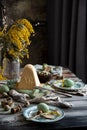 Orthodox Easter table setting with caramel easter cottage cheese cake on wooden light green board on grey wooden table