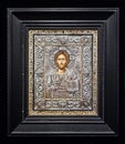 Orthodox Icon of Jesus Christ in a silver embossed frame with semi-precious stones.