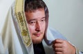 0Orthodox Jew wrapped with traditional religious talit at prayer in the jewish man with kippah