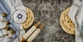 Orthodox Jewish family symbols with cup wine kosher matzah on traditional jewish passover holiday Scrolls torah