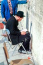 orthodox man prays at the western wall at the holy temple wall in Jerusalem