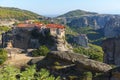 Orthodox Monastery of Varlaam, immense monolithic pillar, green foliage at the background of stone wall in