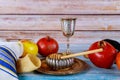 The Orthodox New Year symbols of Rosh Hashanah display a bowl of honey, a shofar, apples, and pomegranates