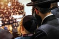 Orthodox pilgrims of Hasidim listen to their rabbi.