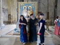 Orthodox priest blessing woman inside Svetitskhoveli Cathedral, Mtskheta, Georgia, 27.07.2022.