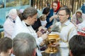 An Orthodox priest sprinkles Christians with Holy water and illuminates the traditional. The great Russian religious holiday