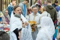 An Orthodox priest sprinkles Christians with Holy water and illuminates the traditional. Religious holiday in Moscow