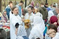 An Orthodox priest sprinkles Christians with Holy water and illuminates the traditional. Religious holiday for Russians