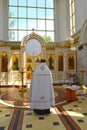 The Orthodox priest stands in front of the iconostasis and the royal gates. Chapel in honor of the Holy Good Princes Peter and Fev