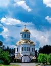 Orthodox temple with golden domes against the background of the cloudy sky. Royalty Free Stock Photo