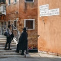 Orthodox traditionally dressed Jewish man walks on Campo di Ghetto Novo which is located in the traditional Jewish