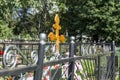 Orthodox wooden cross on a grave in a Christian cemetery in summer vegetation. Memory and sorrow Royalty Free Stock Photo