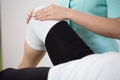 Orthopedic diagnosing painful knee Royalty Free Stock Photo