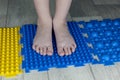 Orthopedic foot mat for child gymnastic. Small children with a flat-bottomed stomach goes barefoot on an orthopedic