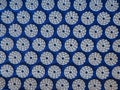 Orthopedic massage blue mat with white spikes. Close-up top view. Alternative medicine for babies, kids and adults.