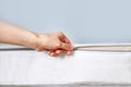 Orthopedic mattress with removable cover. Hand unzips the zipper close-up. Copy space Royalty Free Stock Photo