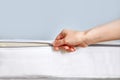 Orthopedic mattress with removable cover. Hand unzips the zipper close-up. Copy space Royalty Free Stock Photo