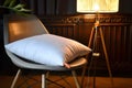 orthopedic pillow on a designer chair, stylish lamp illuminating the scene Royalty Free Stock Photo