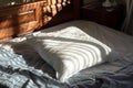 an orthopedic pillow on a wellmade bed, morning sunlight streaming