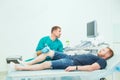 Orthopedist doctor conducting ultrasound examination of patient`s knee in clinic. Ultrasound device scan. Sport Injury, Selective Royalty Free Stock Photo