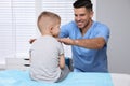 Orthopedist examining child. Scoliosis treatment