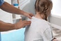 Orthopedist examining child`s back in clinic. Scoliosis treatment