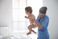 Orthopedist examining cute baby in office