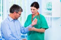 Orthopedist examining hand of patient in surgery