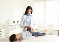 Orthopedist examining little patient`s leg in clinic Royalty Free Stock Photo