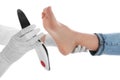 Orthopedist fitting insole on patient`s foot against background, closeup