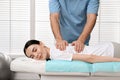 Orthopedist massaging young woman`s back in clinic, closeup. Scoliosis treatment Royalty Free Stock Photo