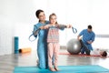 Orthopedists working with children in hospital gym